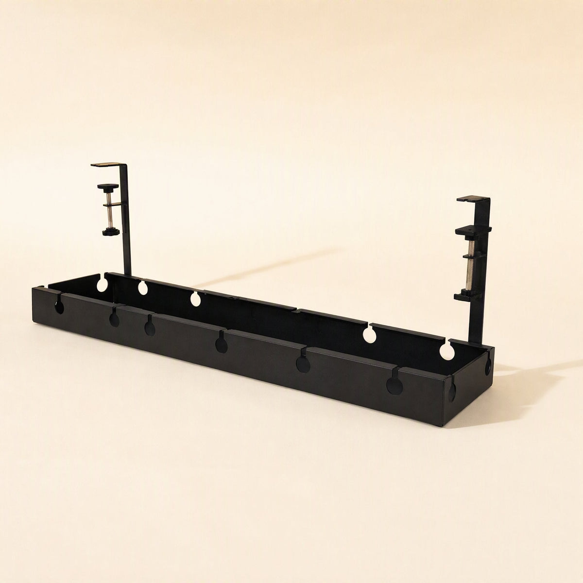 Deskspan – Long black cable tray with clamp brackets at each end and round cutouts along the front, side angle
