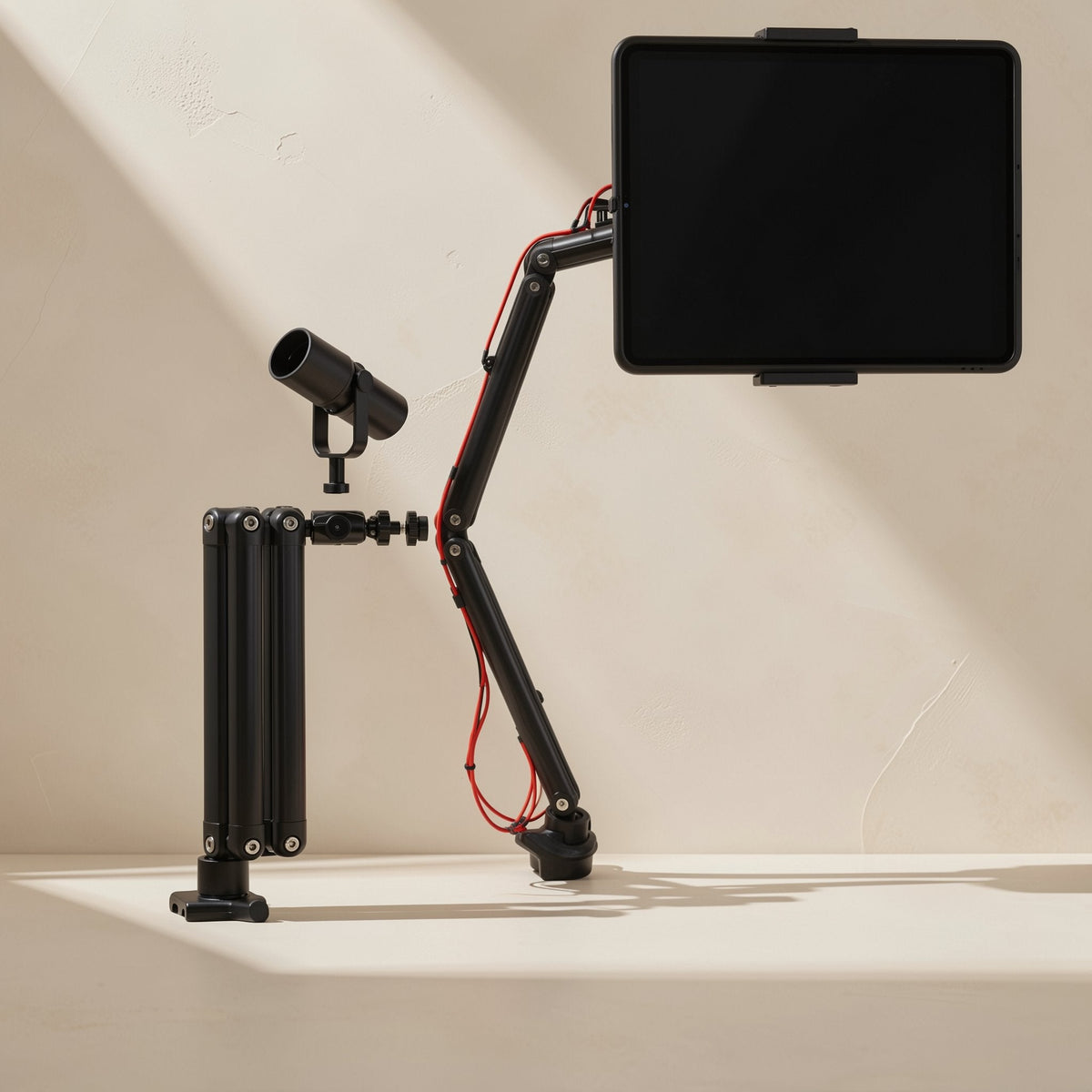 Foldvoice foldable tablet stand with microphone arm holding a tablet and mic beside a folded arm, beige wall