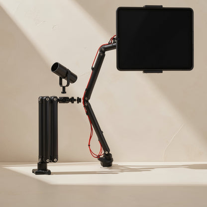 Foldvoice foldable tablet stand with microphone arm holding a tablet and mic beside a folded arm, beige wall