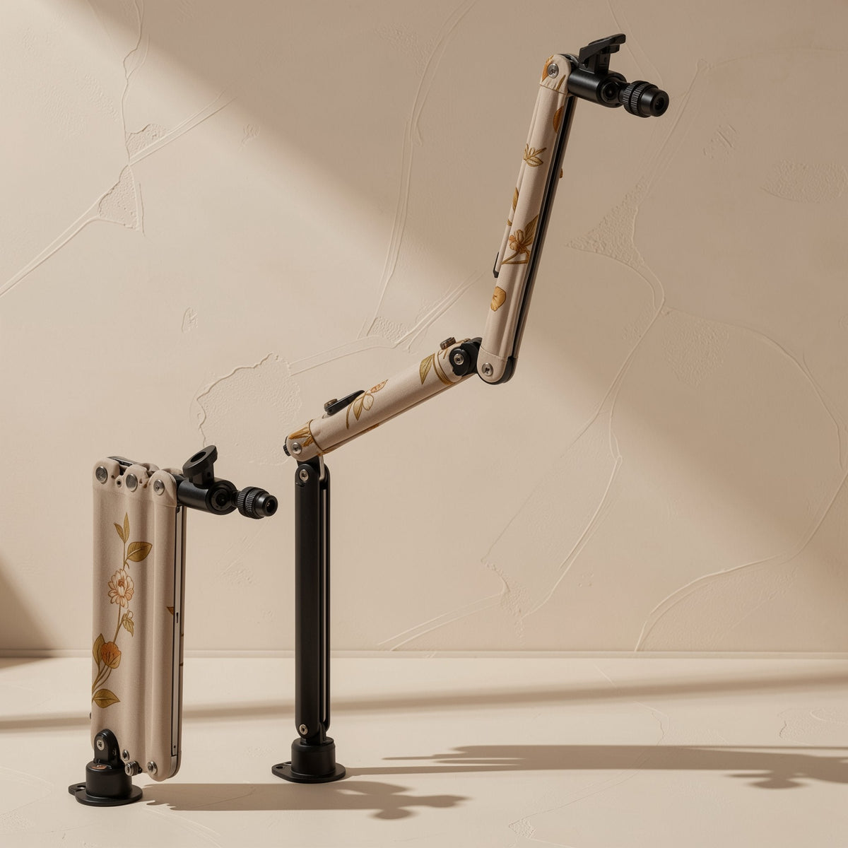 Foldvoice – Two foldable arms with floral print, one folded flat and one extended, on black pole bases