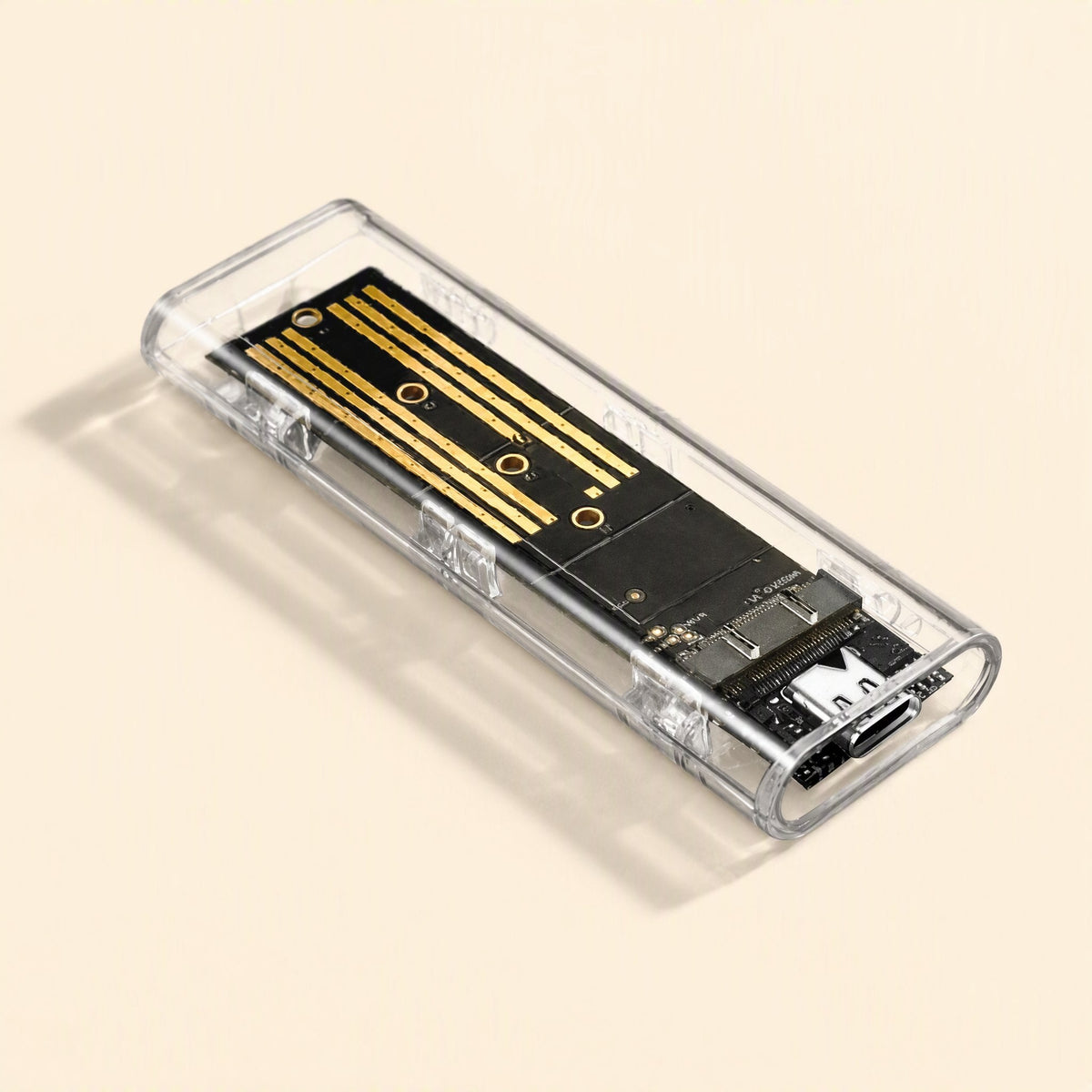 Diskhull M.2 Type-C external hard disk enclosure, clear case at an angle on a cream background