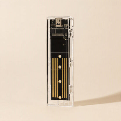 Diskhull – Top-down view of the transparent enclosure showing the black circuit board with gold contact stripes
