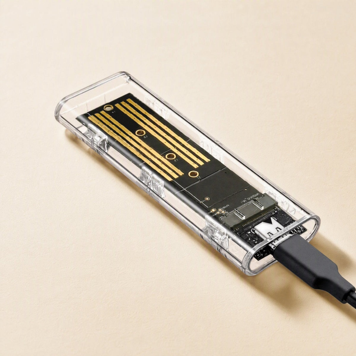 Diskhull – Transparent enclosure with a black USB-C cable plugged into the port at one end