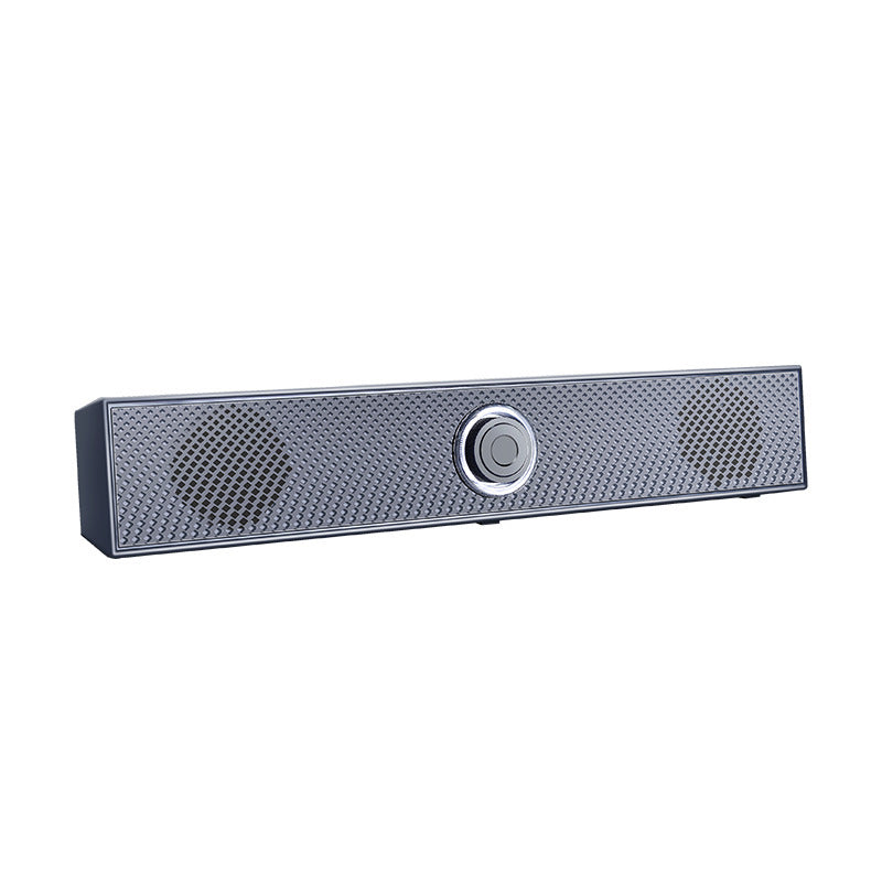Humline – Angled view of the gray bar speaker showing diamond-patterned grille, round driver areas and center knob