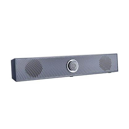 Humline – Angled view of the gray bar speaker showing diamond-patterned grille, round driver areas and center knob