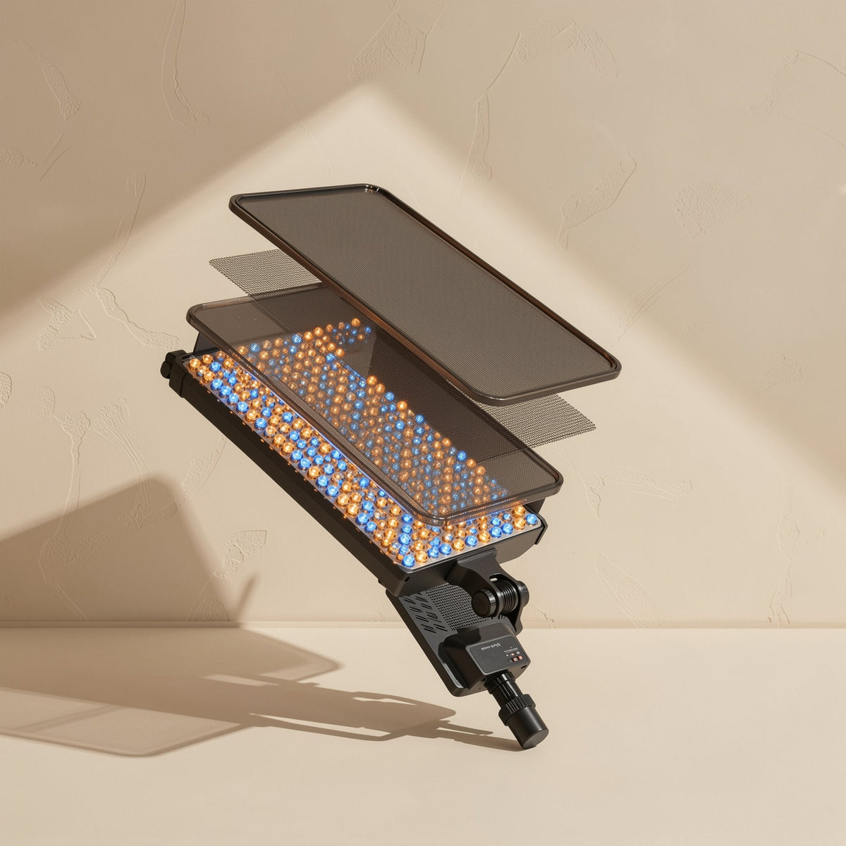 Facegleam – Exploded view of the LED panel showing diffuser layers above rows of orange and blue LED beads