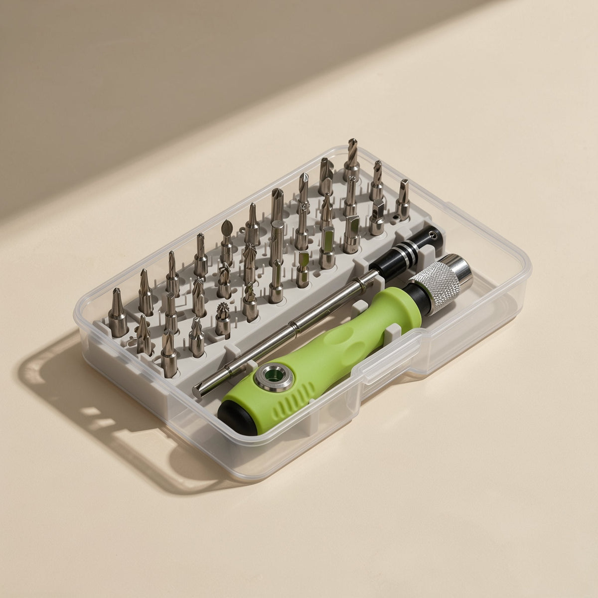 Pocketbit – Overhead view of the open case holding rows of steel bits and the green handle with extension rod
