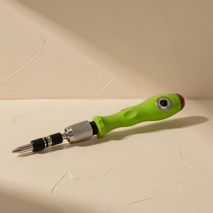 Pocketbit – Green handle lying on its side with a flat-head bit fitted and knurled silver collar visible