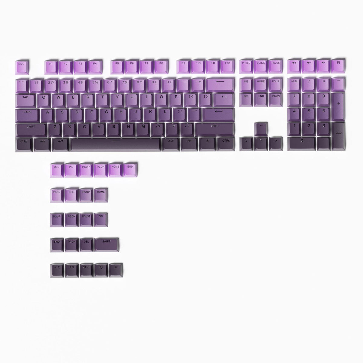 Glowfade Translucent Gradient Mechanical Keyboard Keycaps full set laid out flat, purple fading to dark gray