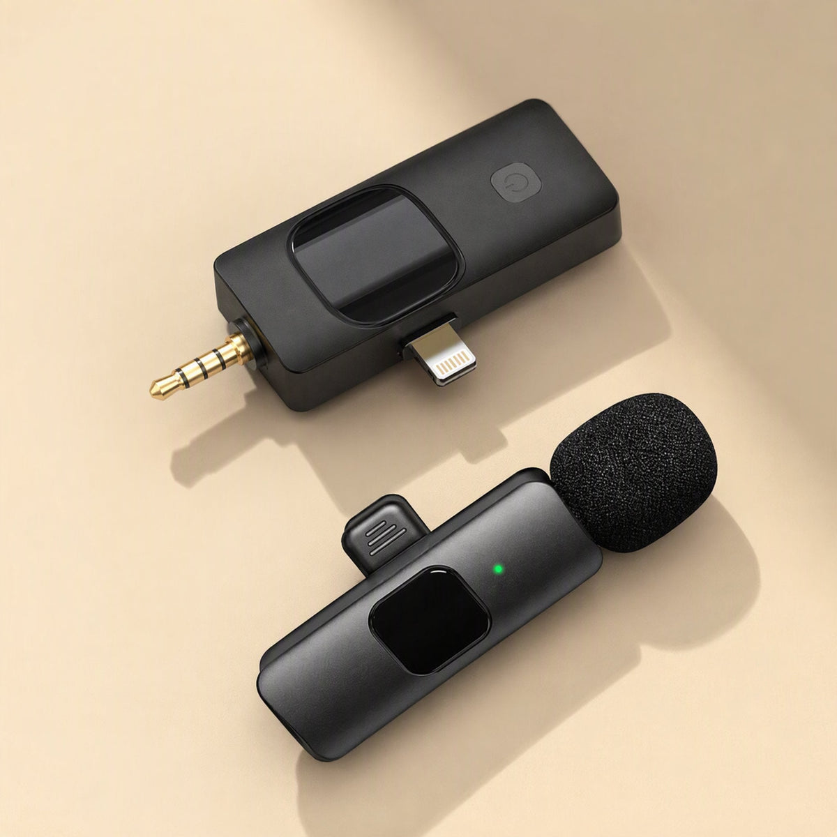 Voiceclip – Black receiver with 3.5mm and Lightning plugs above a clip-on mic with green indicator light, angled view