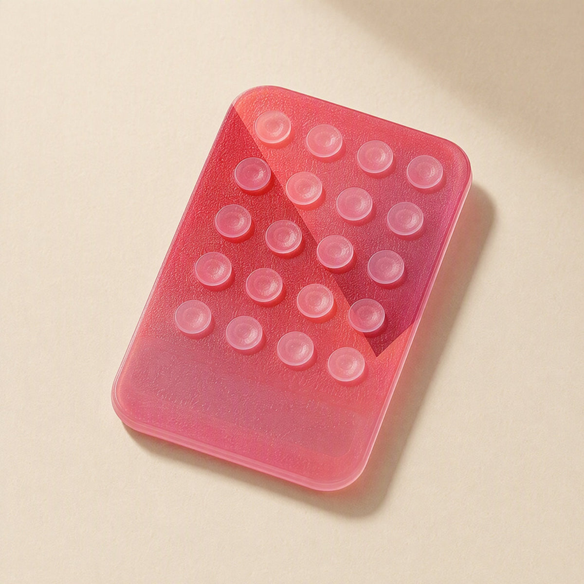 Suctionstay – Pink translucent suction cup phone holder shown from above with the suction cups visible