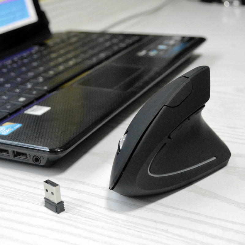 Upright Vertical Optical Mouse – black vertical mouse on a white desk next to a laptop and a small USB receiver