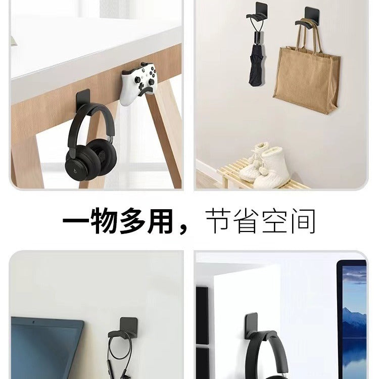 Hearhook mounted under a desk and on walls, holding headphones, a game controller, an umbrella and a tote bag