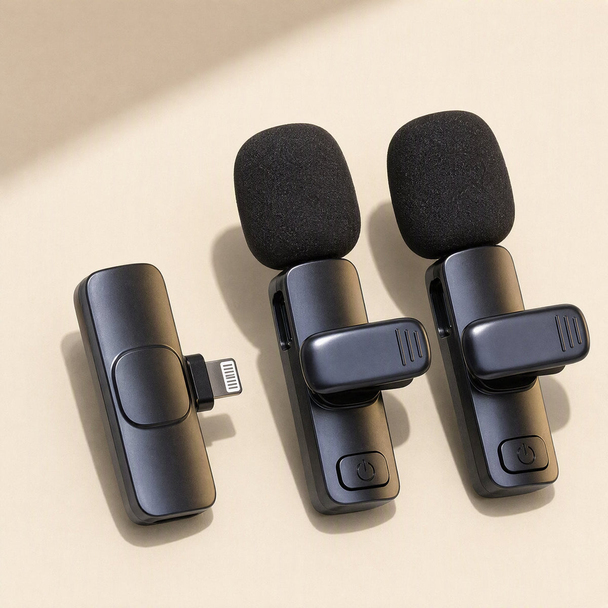 Freevoice Bluetooth Wireless Lavalier Microphone: two clip-on mics and a Lightning receiver on a beige surface