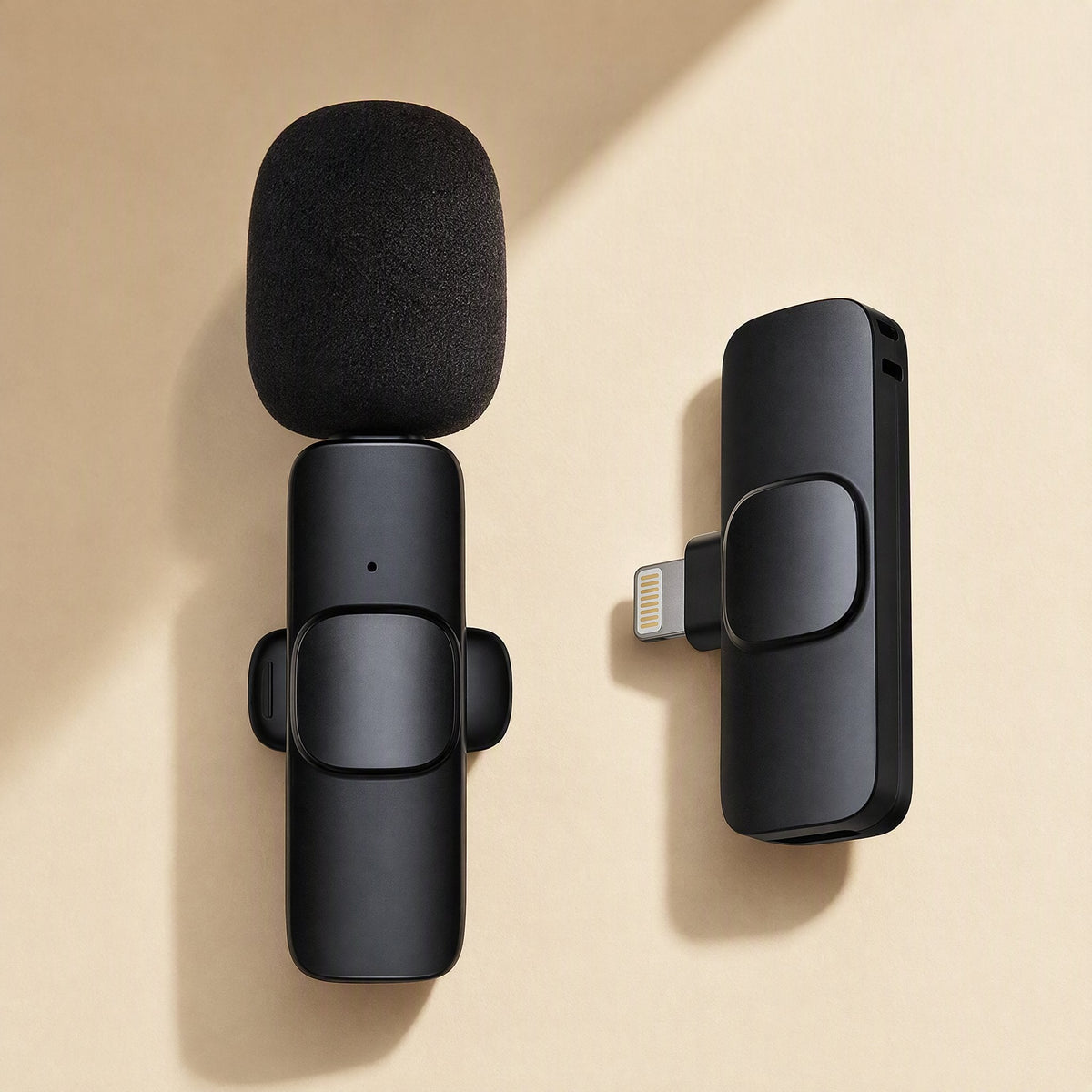 Freevoice – Single black lavalier mic with foam windscreen beside a Lightning receiver on a cream background