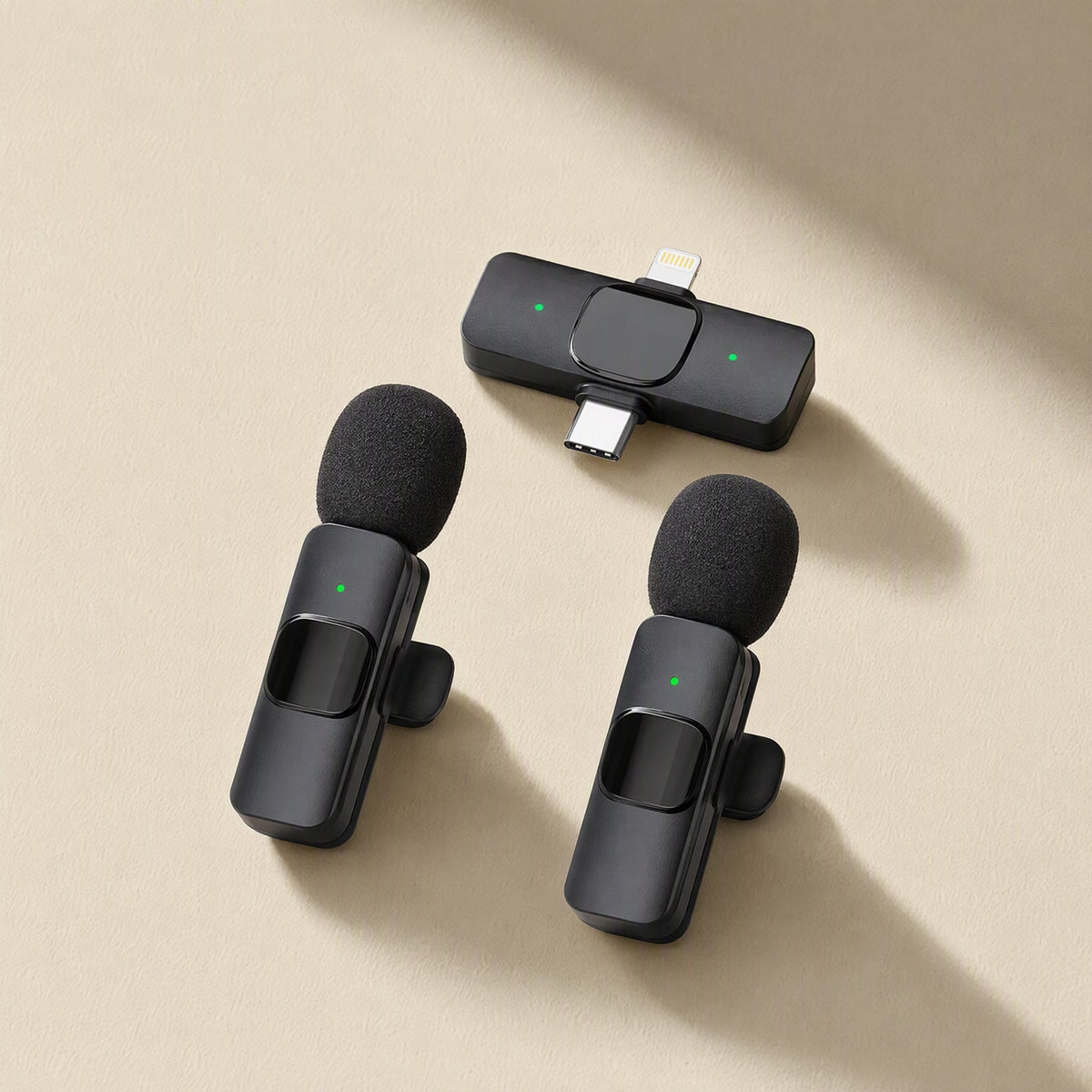 Freevoice – Two lavalier mics with green indicator lights beside a dual Lightning and USB-C receiver on beige