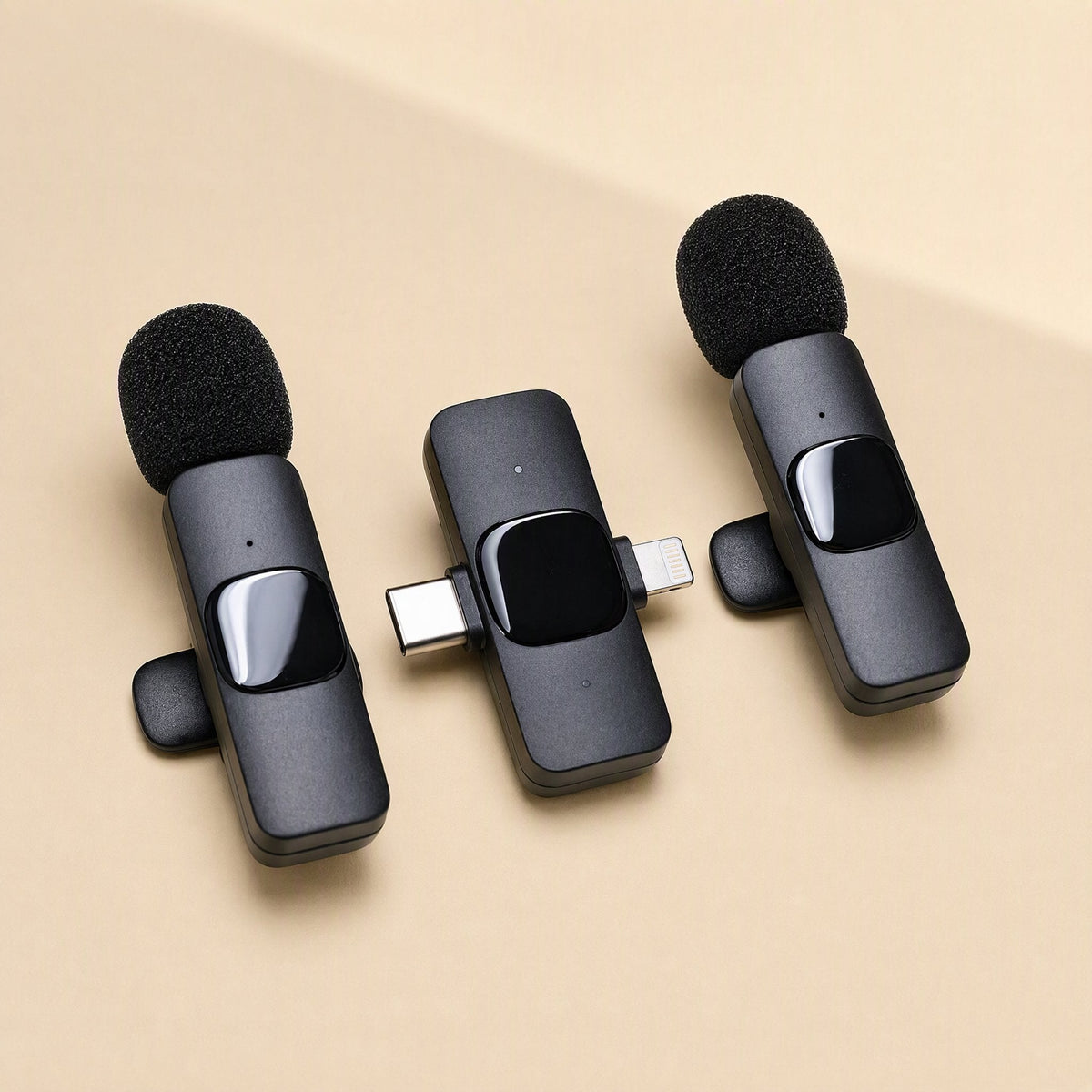 Freevoice – Two clip-on mics flanking a dual-connector receiver with USB-C and Lightning plugs, top-down view