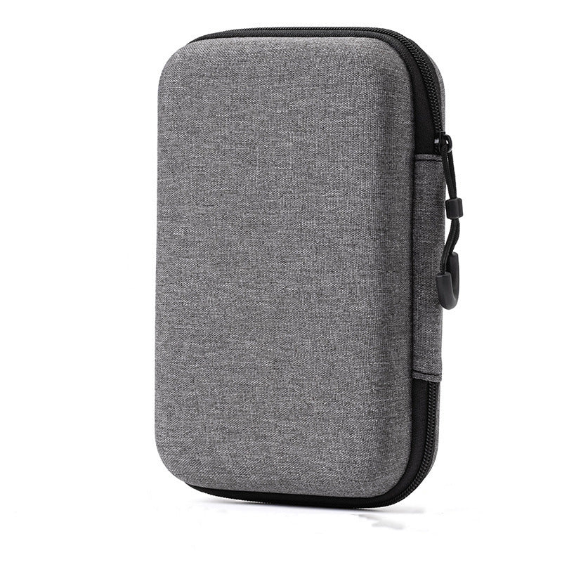 Pixelpouch – Gray zippered hard-shell pouch standing upright with black zipper pull, front angle
