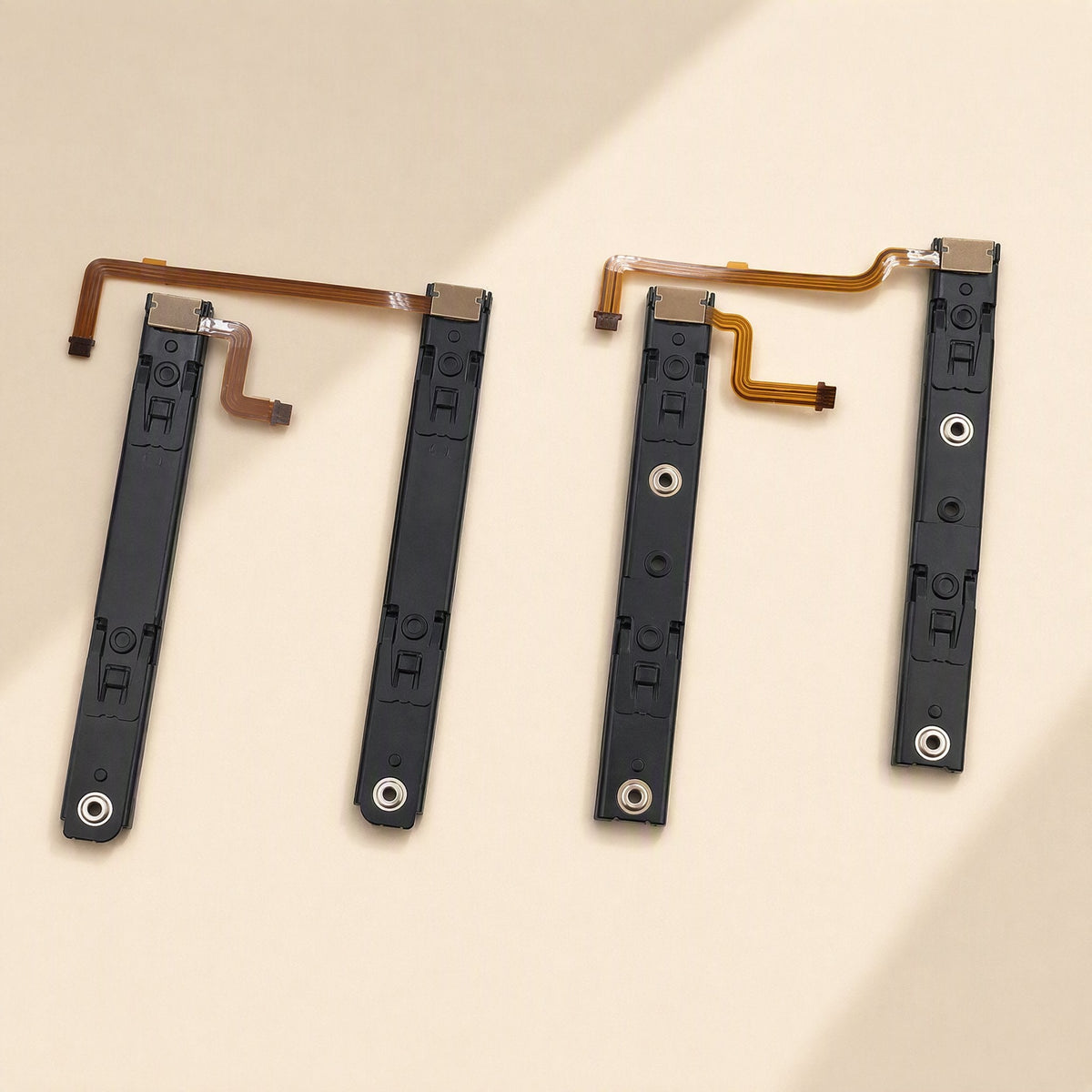 Railglide Steel Switch OLED Slide Rail pair of black rails with orange flex cables on a beige background