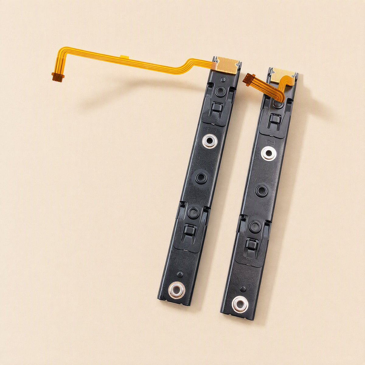 Railglide – Left and right slide rails standing upright, showing metal screw points and ribbon cables at the top