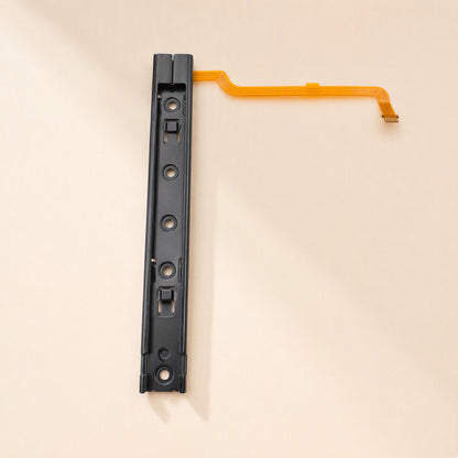 Railglide – Single black slide rail from above with four screw holes and a long orange flex cable extending right