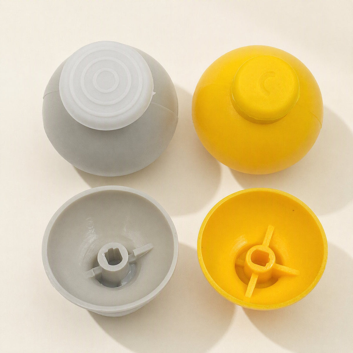 Rockergrip Plastic Rocker Cap in gray and yellow, shown top-down with domed tops and hollow undersides