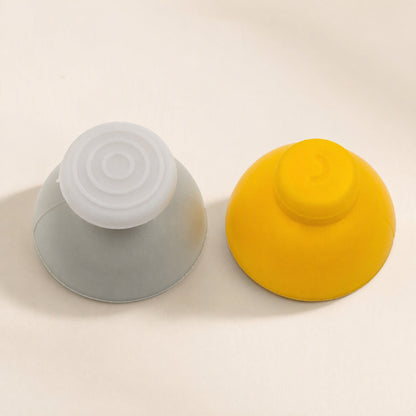Rockergrip – Gray and yellow rocker caps side by side from the side, showing dome tops with textured and smooth finishes