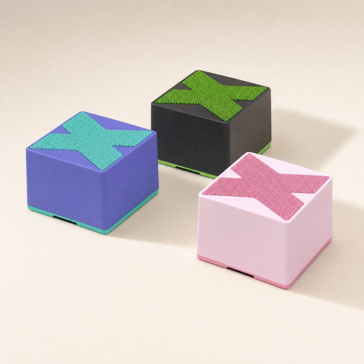 Meshsound – Purple, black and pink cube speakers with X mesh tops and colored base trims, seen from a low angle