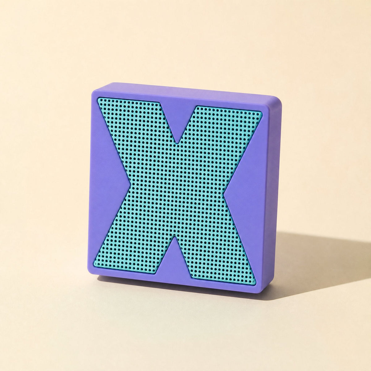 Meshsound Bluetooth Small Speaker – purple speaker standing upright, front view of its teal X-shaped metal mesh grille