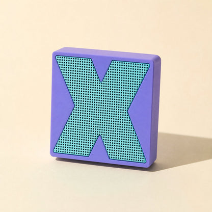 Meshsound Bluetooth Small Speaker – purple speaker standing upright, front view of its teal X-shaped metal mesh grille