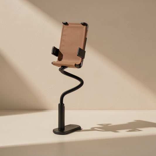 Alloyprop – Black gooseneck phone holder stand with weighted base holding a tablet upright against a beige backdrop