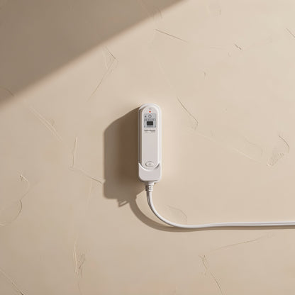 Stickcord – White power strip mounted on a textured beige wall with a white cord trailing across it