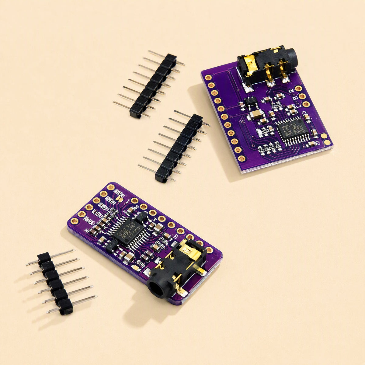 Sounddecode Digital Audio DAC Decoder Board in two purple sizes with separate black pin headers on beige