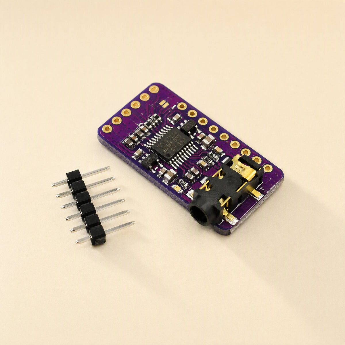 Sounddecode – Compact purple DAC board seen from the side with a black audio jack and six-pin header strip