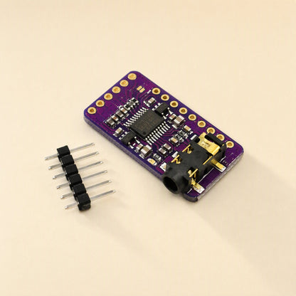 Sounddecode – Compact purple DAC board seen from the side with a black audio jack and six-pin header strip