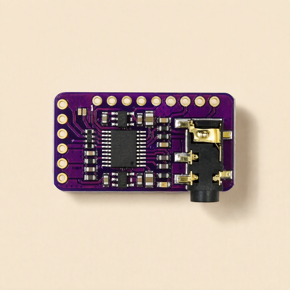 Sounddecode – Top view of purple DAC board showing gold-ringed pin holes, central chip and audio jack on the right