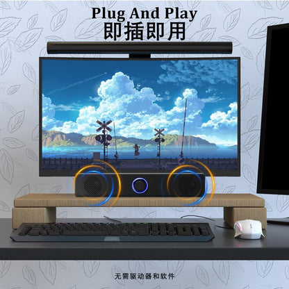 Duetrix – Soundbar under a curved monitor on a wooden desk riser beside a keyboard and mouse, labeled Plug And Play
