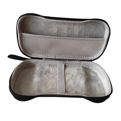 Pockette – Empty open case showing the soft grey lining, white elastic band, and mesh pocket in the lid