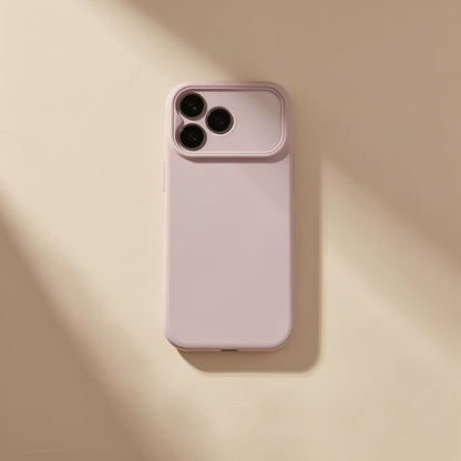 Gripcup – Plain blush pink phone case with triple camera cutout lying flat on a warm beige surface in soft light