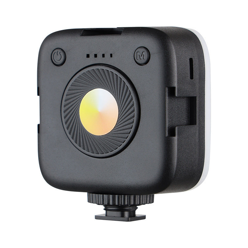 Selfbeam – Back of the compact black square LED light with power and mode buttons, four indicator dots and a round color dial