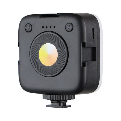 Selfbeam – Back of the compact black square LED light with power and mode buttons, four indicator dots and a round color dial