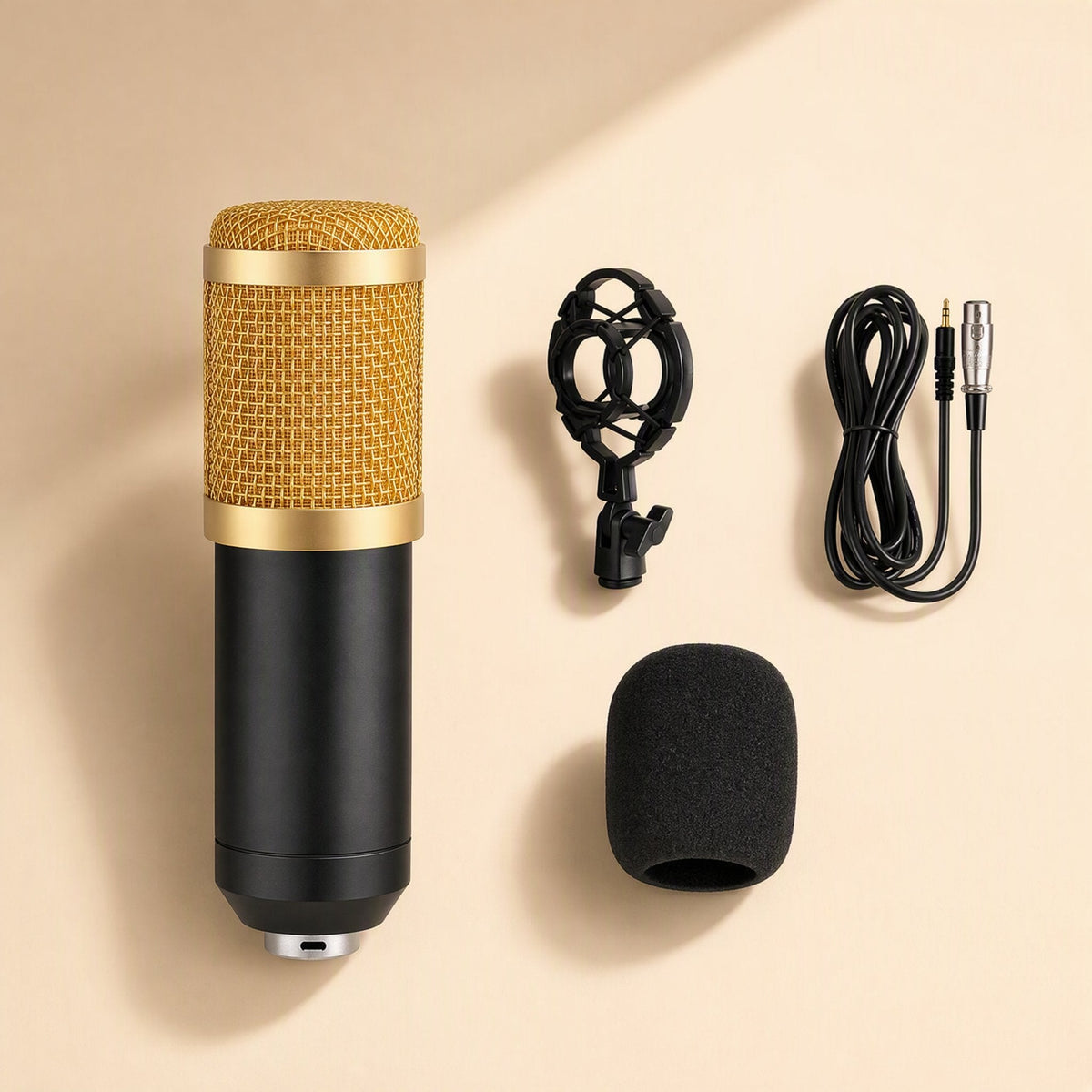 Soundloom – Gold-mesh condenser microphone with black body, shock mount, XLR cable and foam windscreen on beige