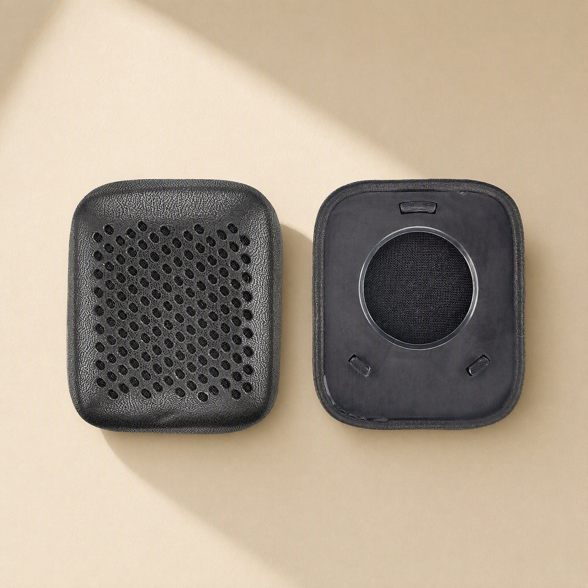Earsoft – Pair of black perforated ear pad covers, one shown front and one showing the back with clips
