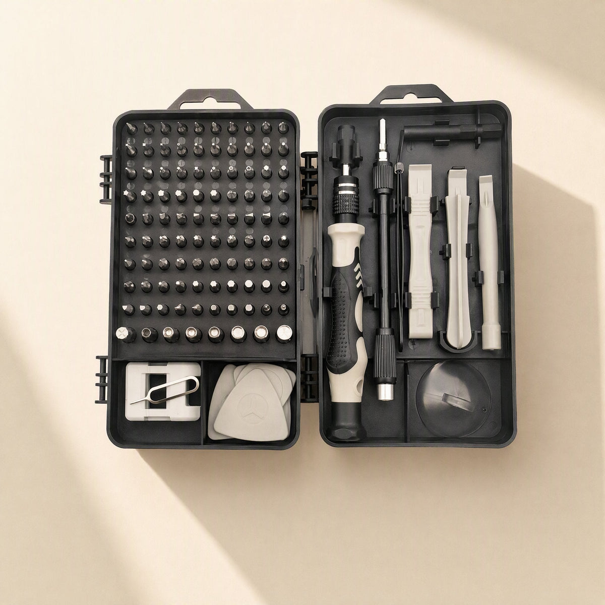 Bitnest – Open black case with grid of screwdriver bits, ratchet handle, spudgers, pick and suction cup, gray accents