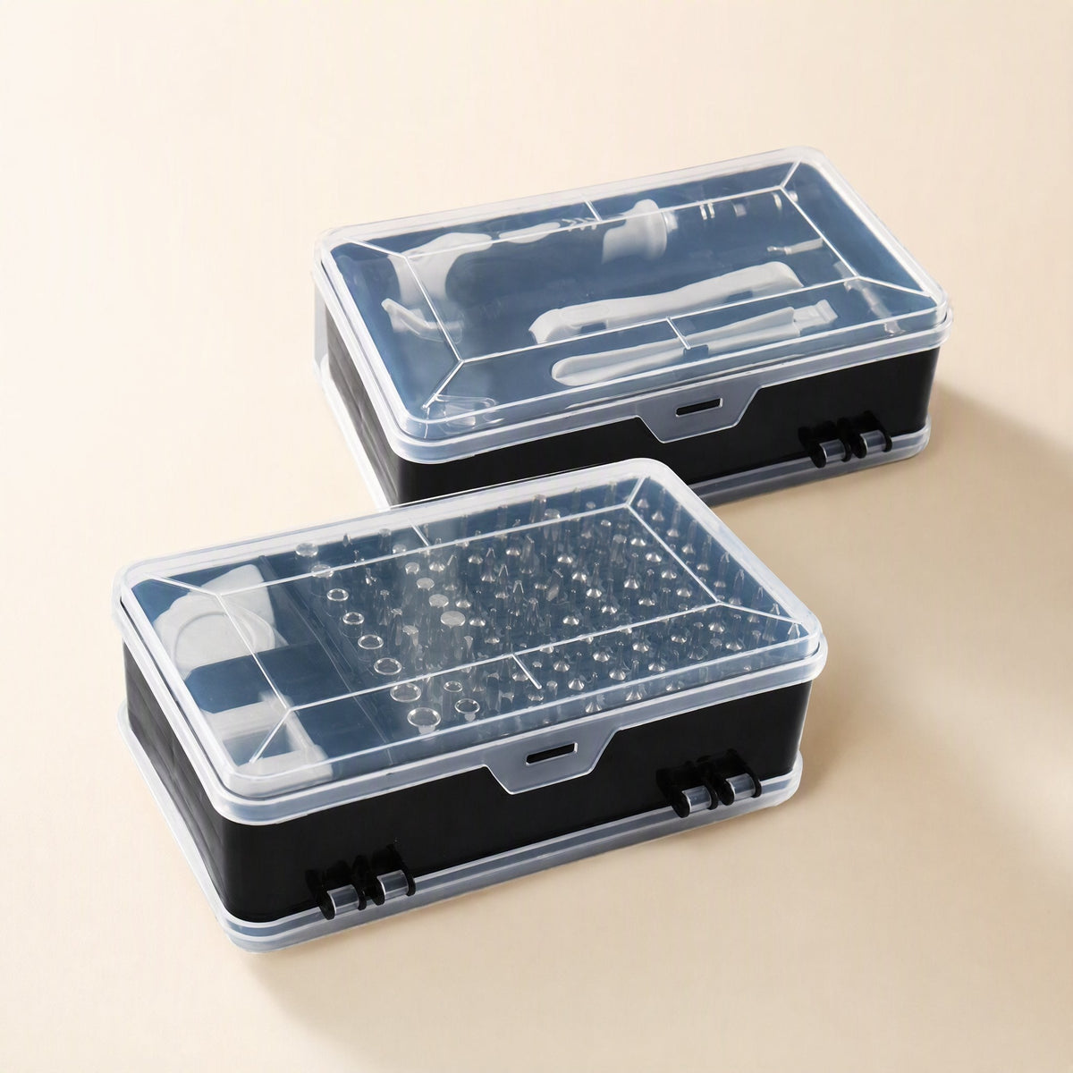 Bitnest – Two closed clear-lidded black cases stacked at an angle, one holding bits, the other holding tools