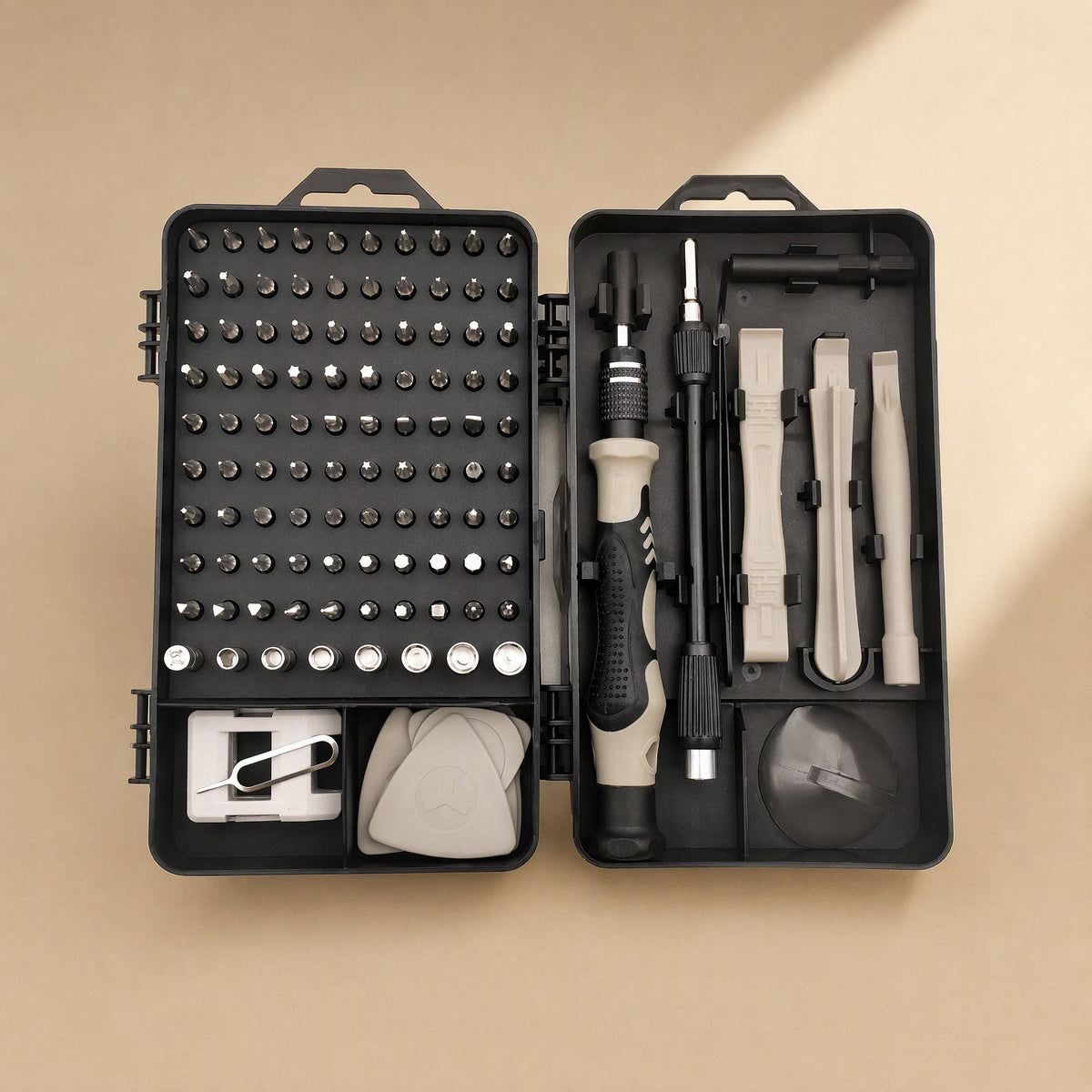 Bitnest – Open case from above with a tan-accented handle, bit grid, opening picks, SIM ejector pin and suction cup