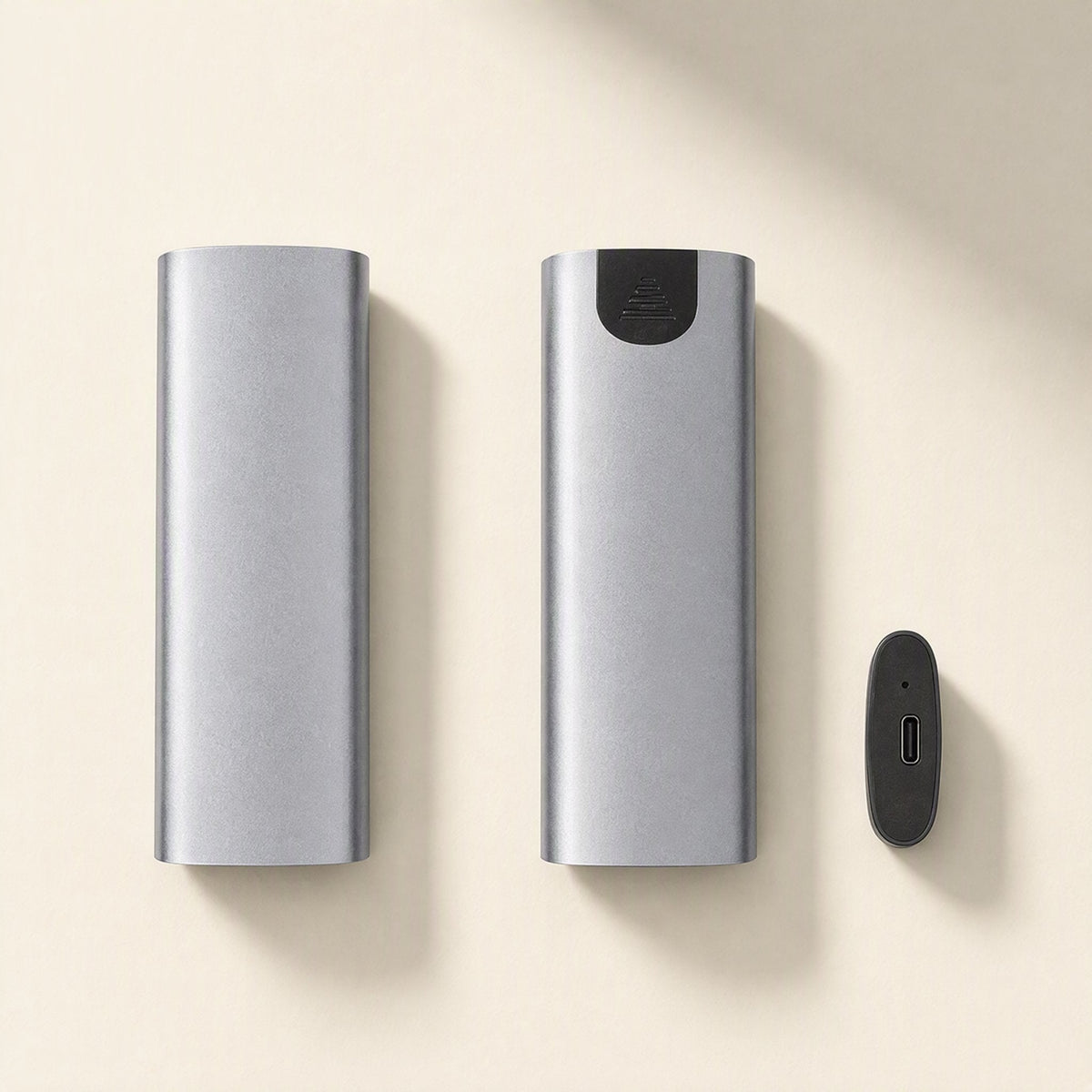 Driveguard – Gray aluminum enclosure bodies side by side with a black end cap showing the USB-C port, on a cream background