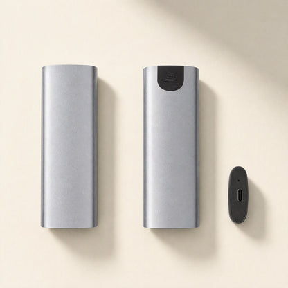 Driveguard – Gray aluminum enclosure bodies side by side with a black end cap showing the USB-C port, on a cream background