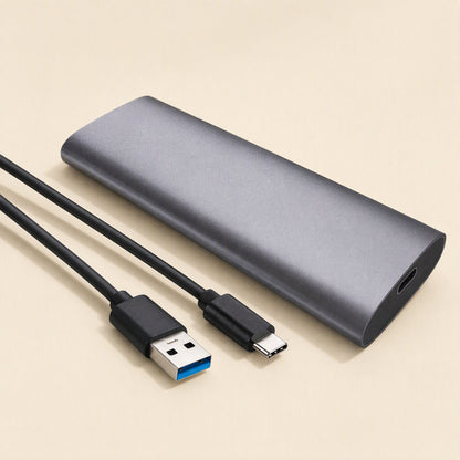 Driveguard – Closed gray enclosure lying flat with a USB-A to USB-C cable coiled in front of it