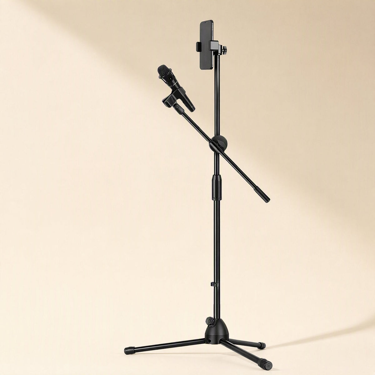 Tripodrise – Black floor stand with boom arm holding a handheld microphone and a smartphone clamped at the top